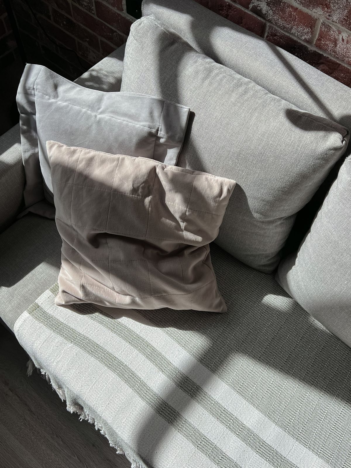 Cushions of different sizes on a sofa