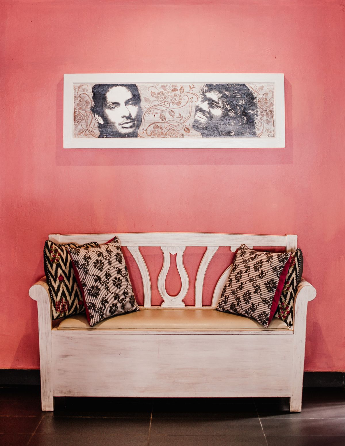 Artwork hung above a white sofa