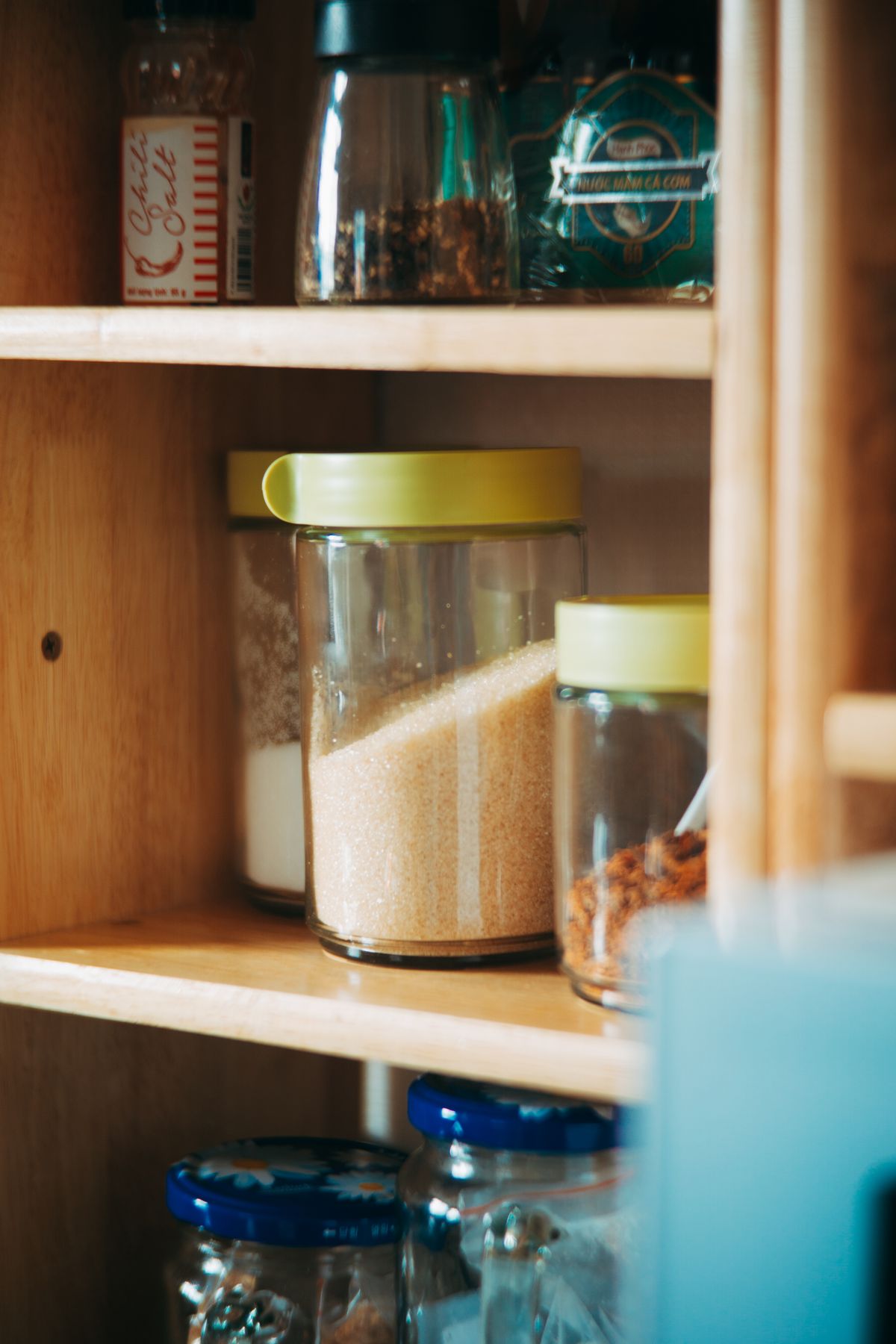 Food jars arranged on pantry shelves