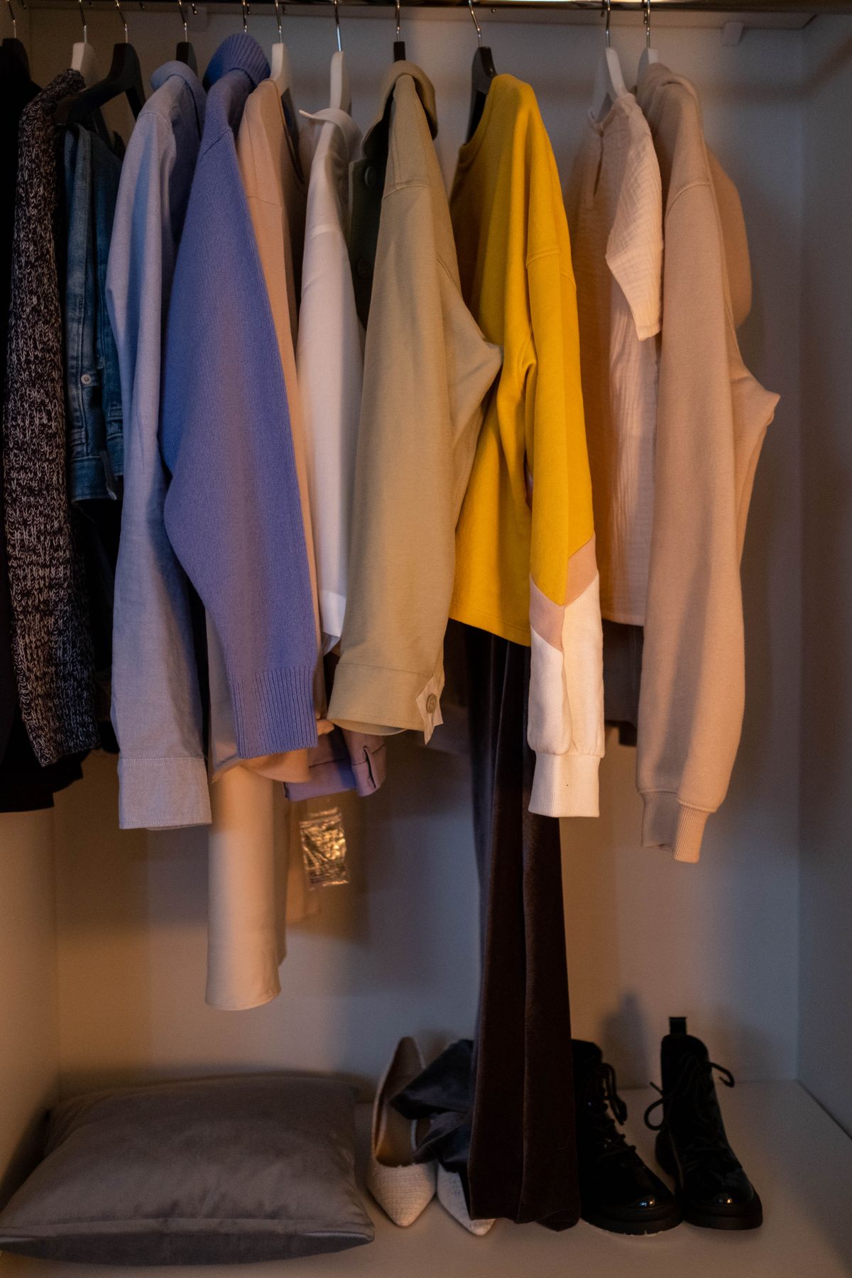 Hanging clothes and shoes arranged in a wardrobe