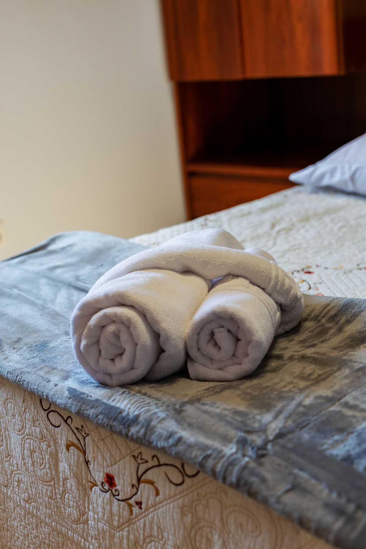 Towels placed on a neatly made bed