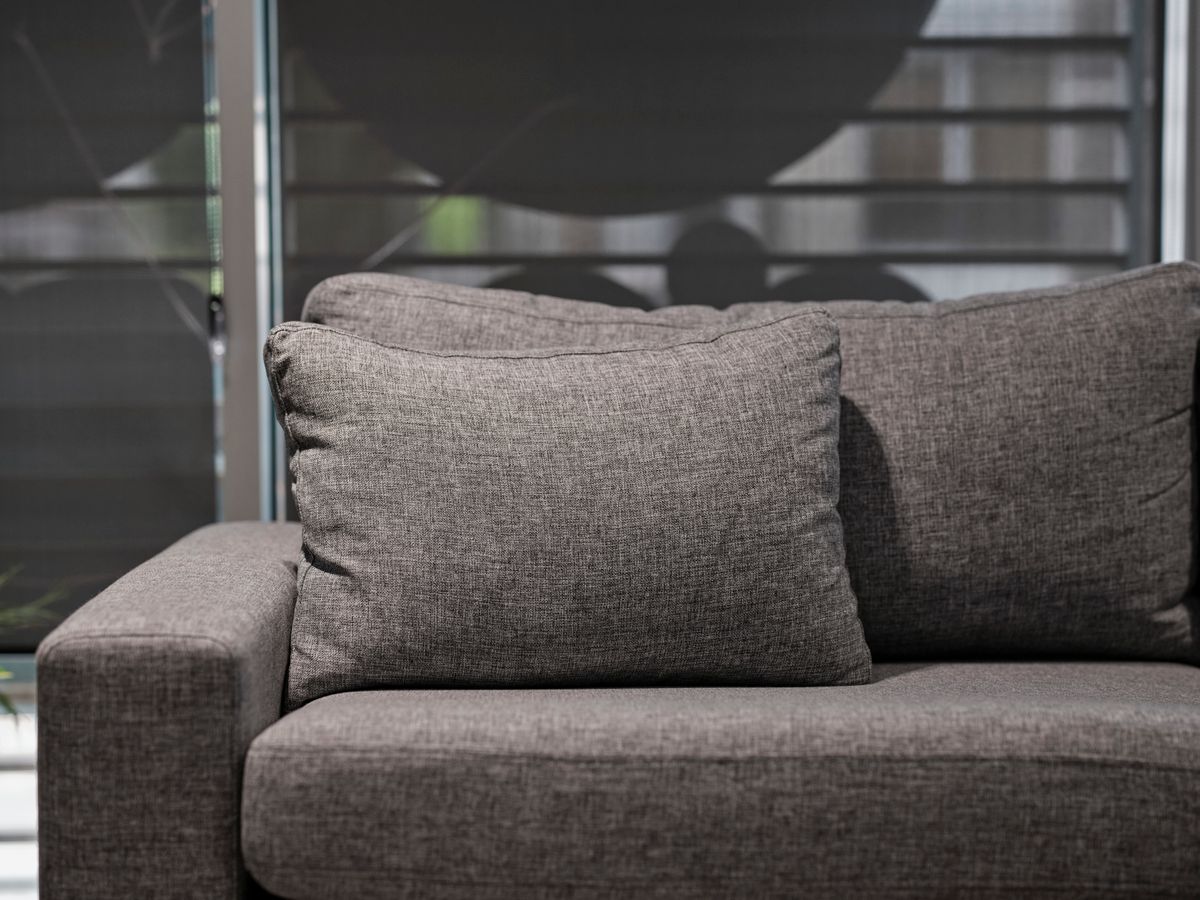 Close view of grey sofa upholstery and cushions