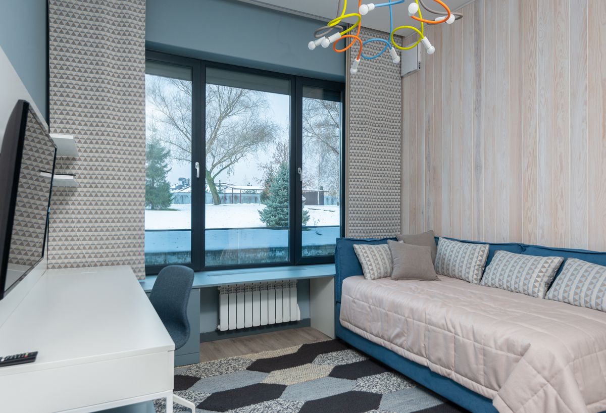 Room with a sofa and desk beside the window