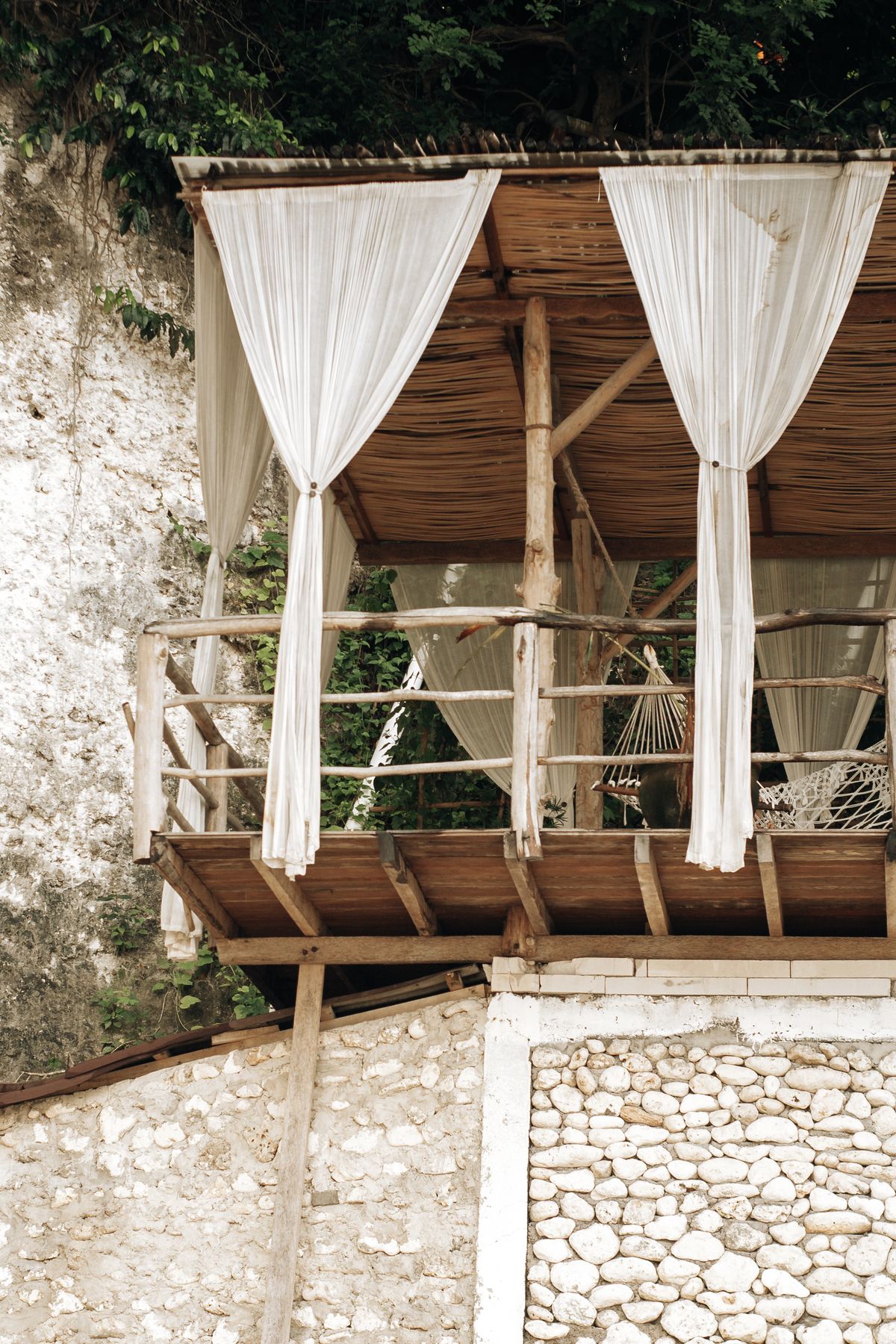 Light curtains on a balcony with greenery