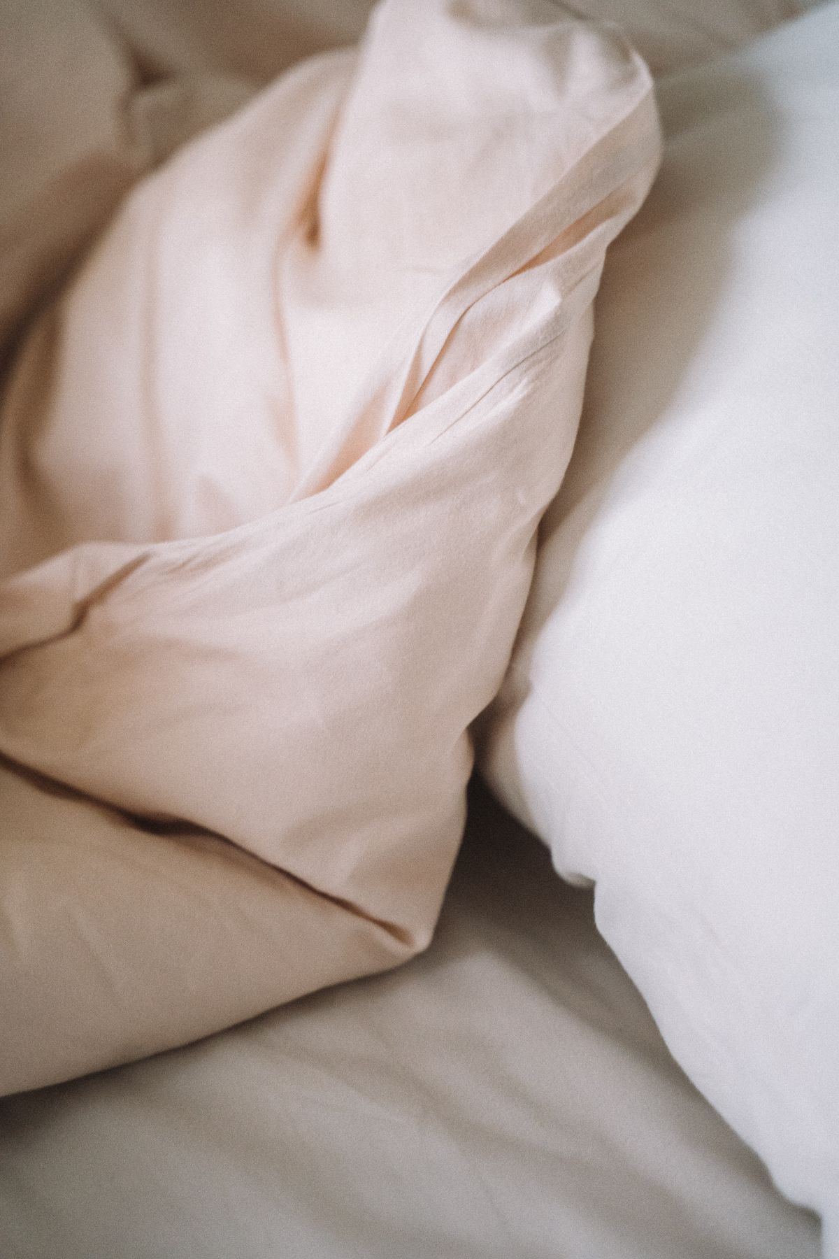 Detail of pale sheets and pillows