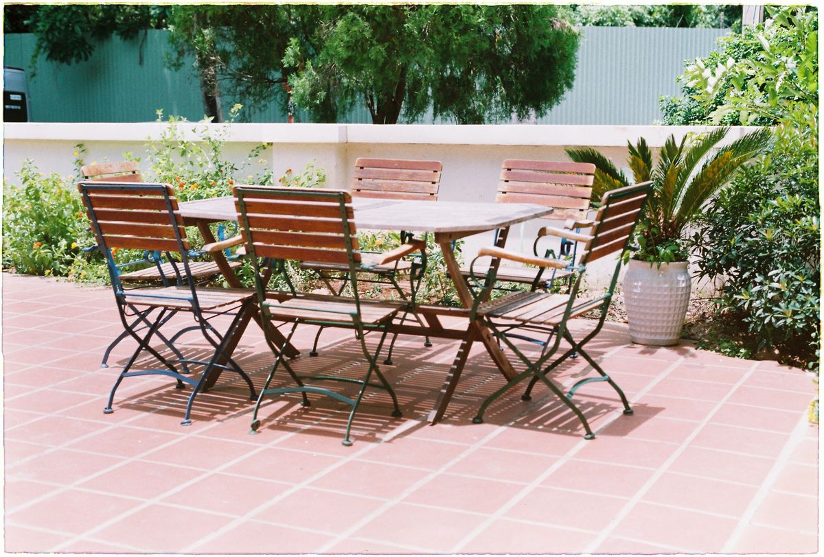 Wood-and-metal table and chairs on a patio