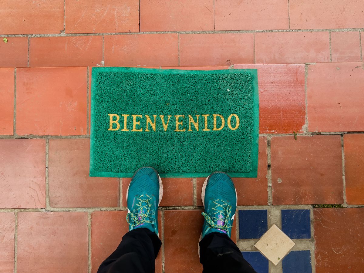 Green doormat in front of a doorway